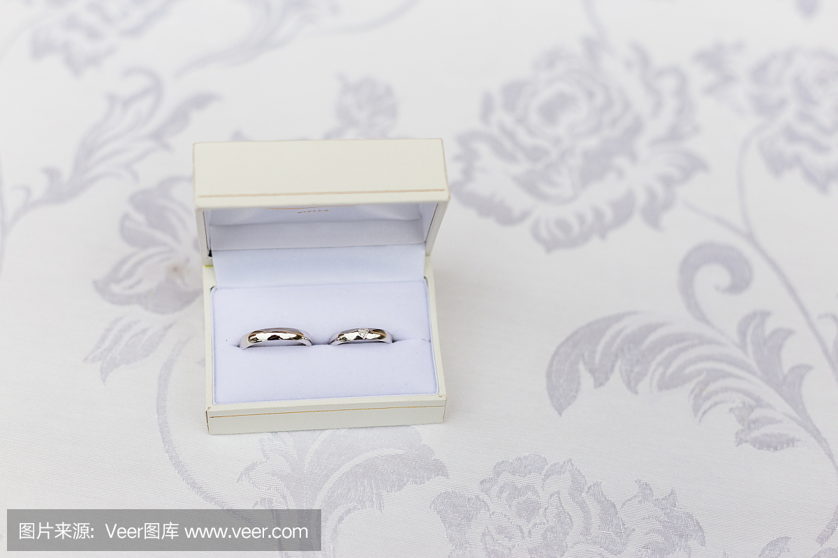 金結婚戒指放在緞子枕頭上